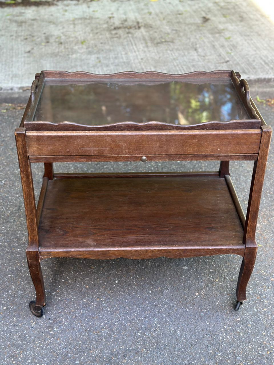 Extendable wooden bar trolley with a glass top from the 1930s.
