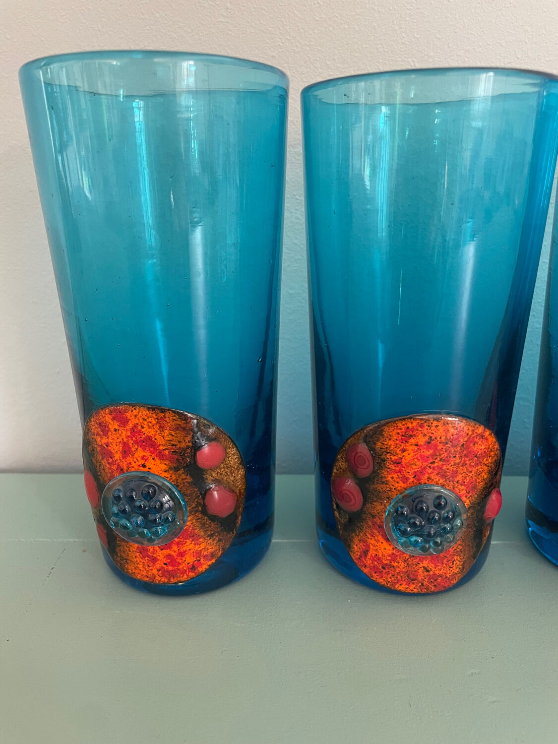 Six blue blown glass and enamel on copper glasses.