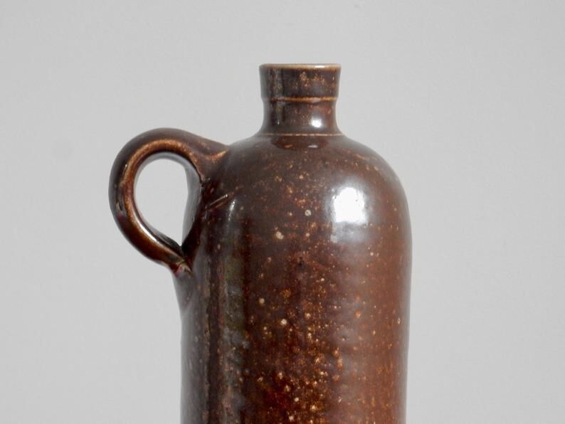 Enamelled brown sandstone bottle with handle