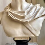 Beige bust of Apollo on black pedestal