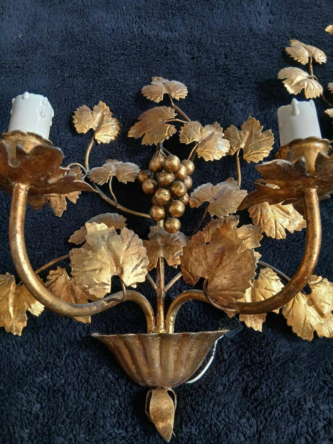 Stunning vintage wall lights in gilded iron with vine and grape decor from Italy.