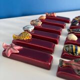 Set of vintage red ceramic knife holders, marine motif, retro style