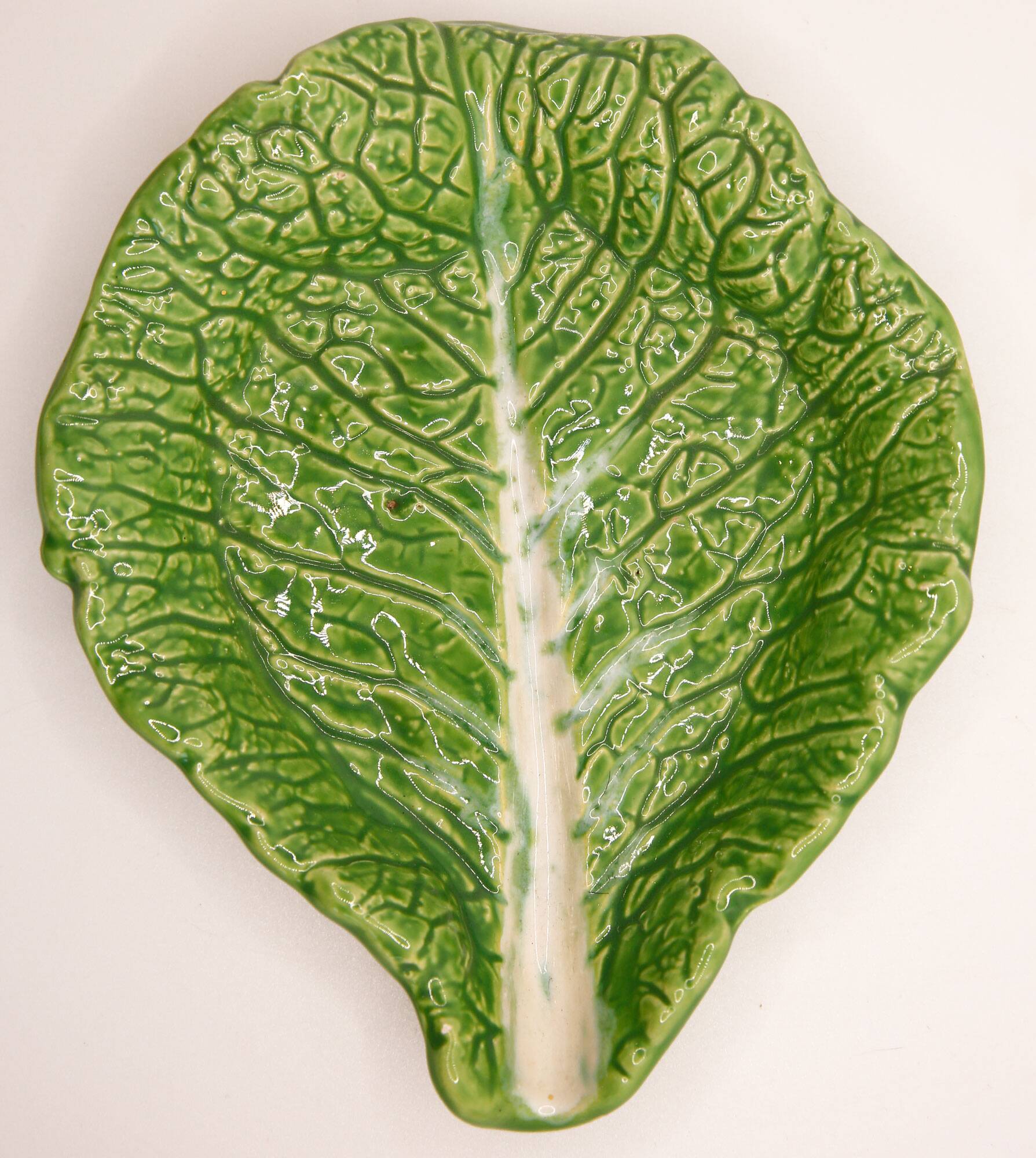 Trompe l'oeil cup bright green cabbage leaf in slip