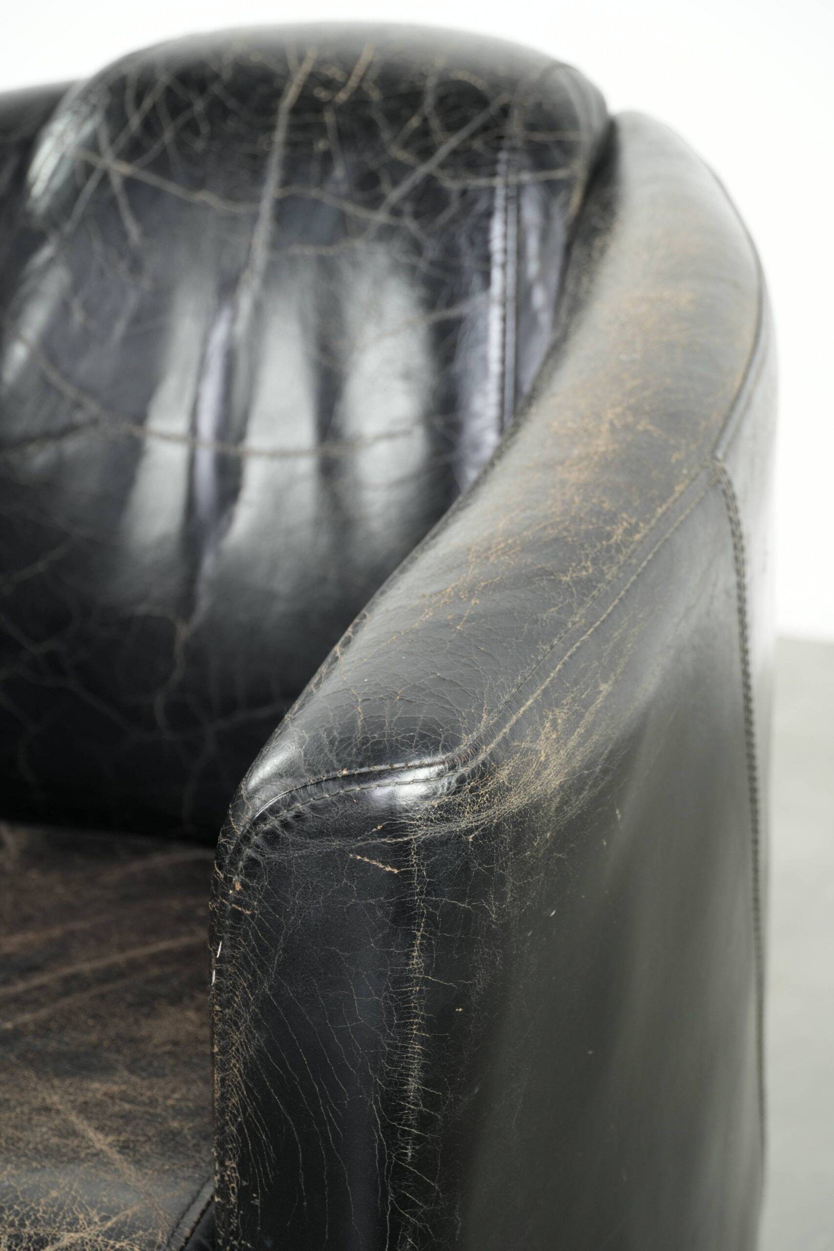 Black vintage cowhide aviator design armchair with characterful appearance