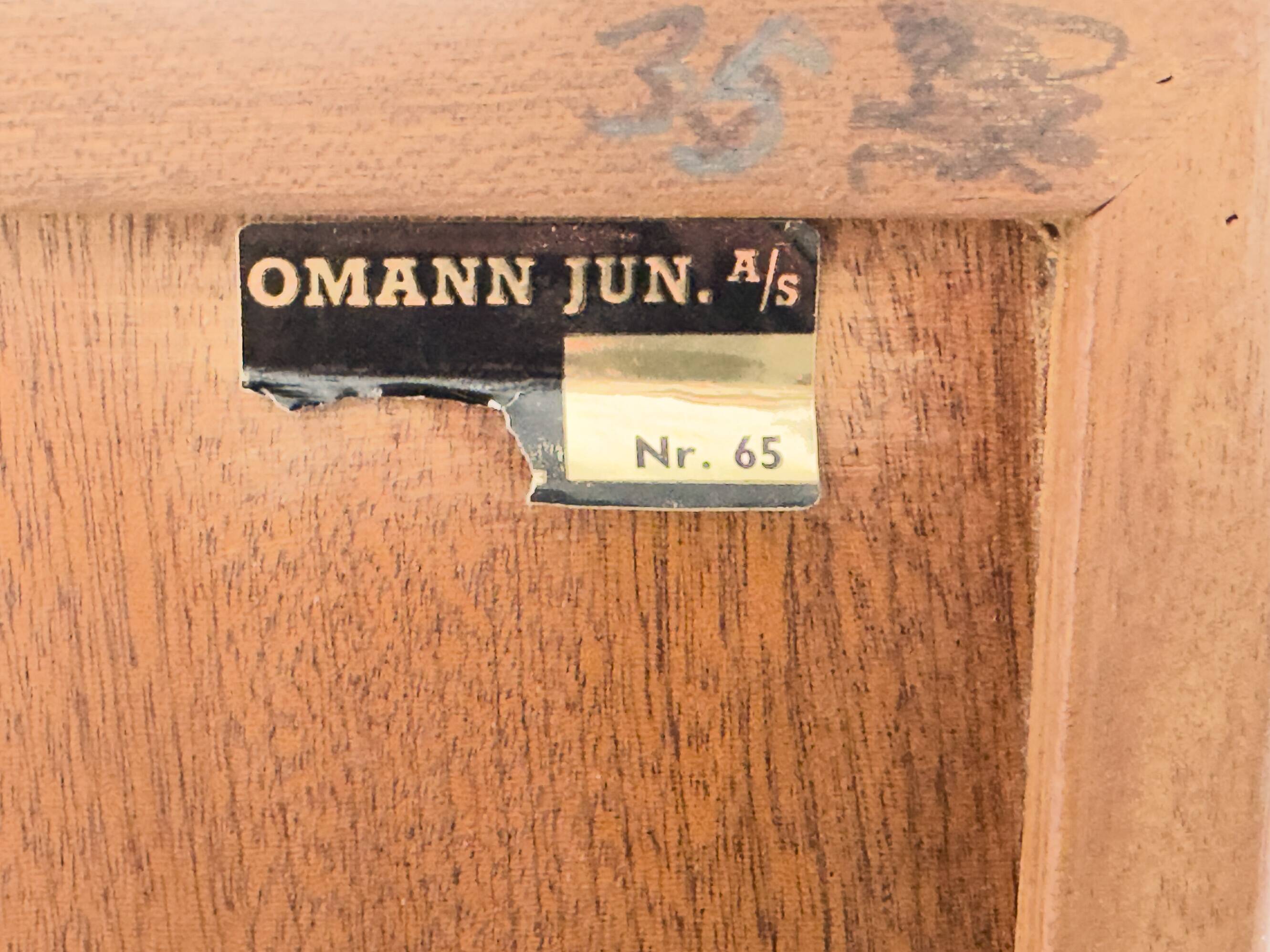 Narrow teak bookcase with two doors by Omann Jun, 1970s