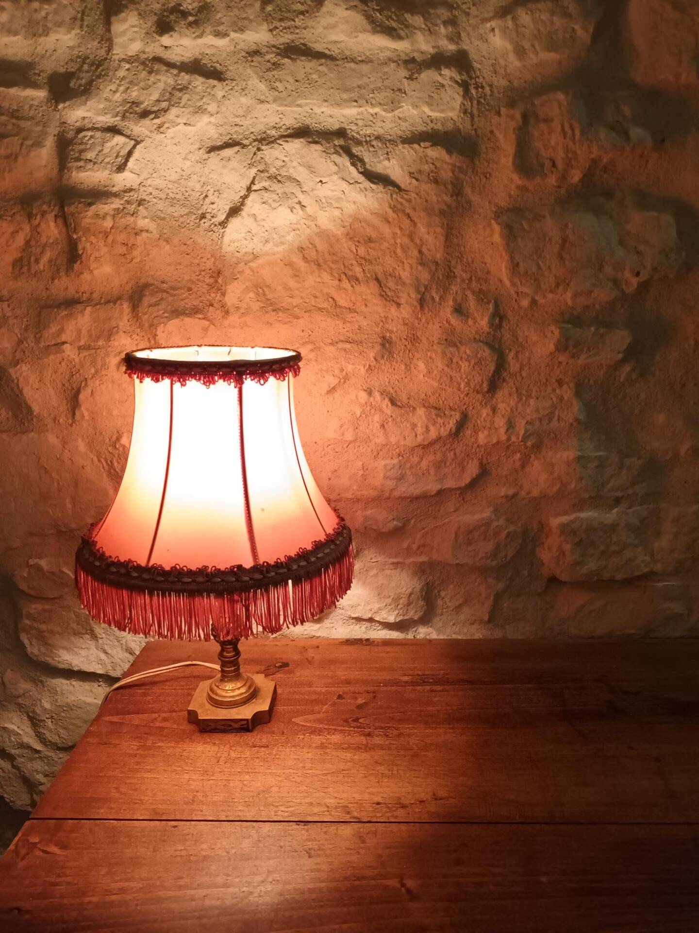 Vintage lamp, pink fringed pagoda shade and brass base.