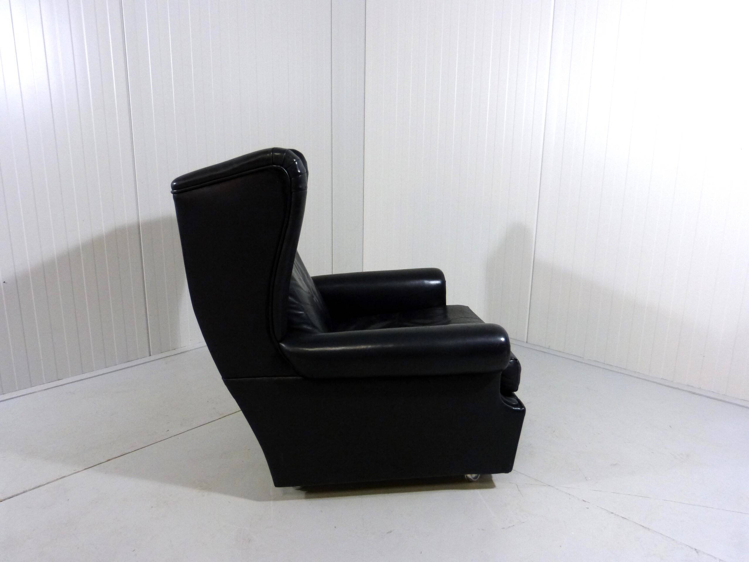 Black leather wingback chair on wheels 1960’s