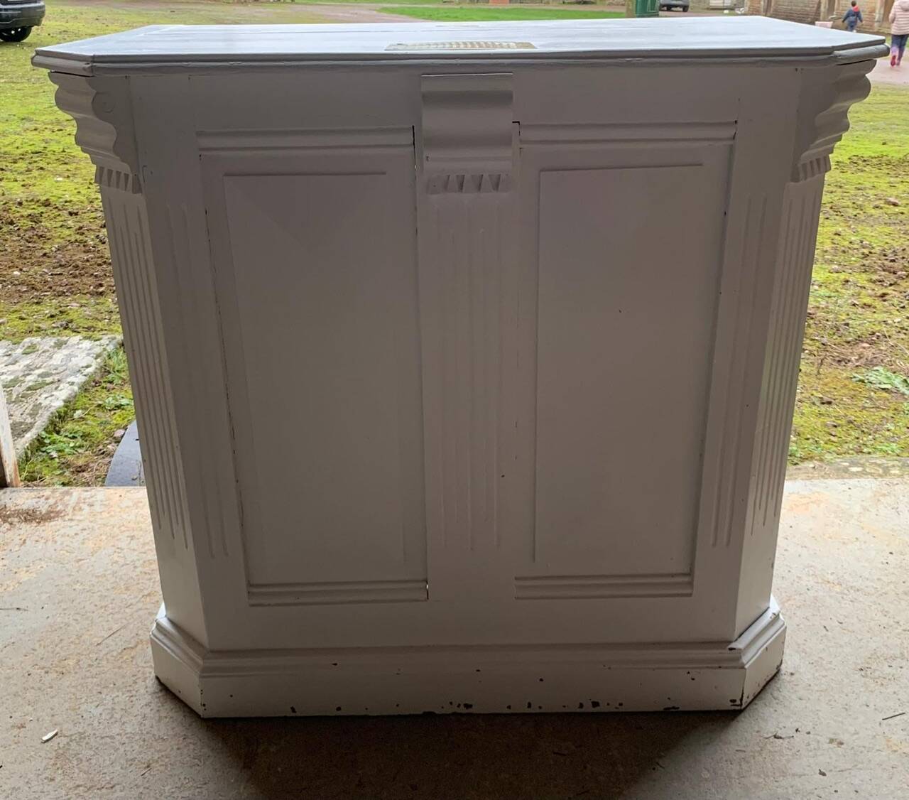 White counter with brass coin mechanism
