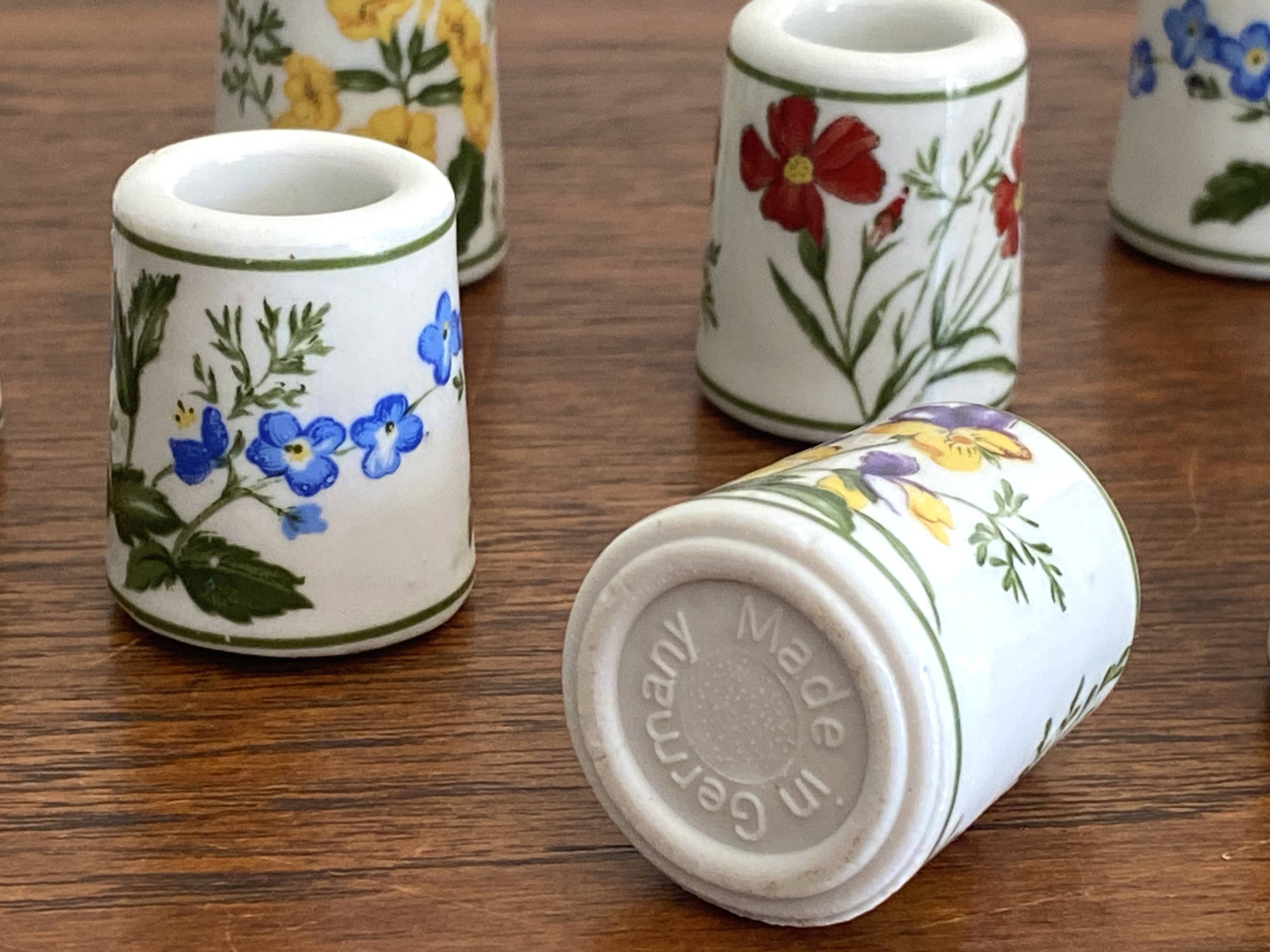 Set of 9 mini vintage porcelain candle holders decorated with spring flowers.