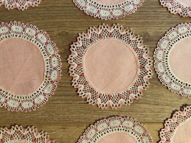 11 pink hand-lace coasters
