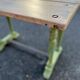 Old table with patinated green legs