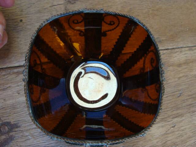 Small glass cup in metal frame