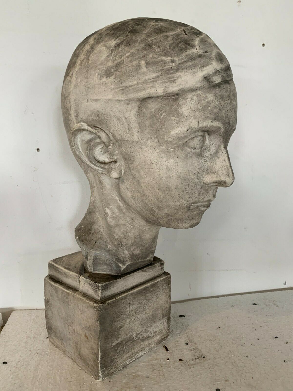 Bust of a young man in plaster signed Gerard Choain XX century