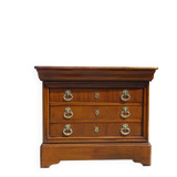 Chest of drawers with decorated handles in the Louis XVI style.