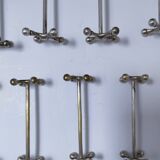 Eleven 70s design metal "crosshair" knife holders