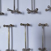 Eleven 70s design metal "crosshair" knife holders