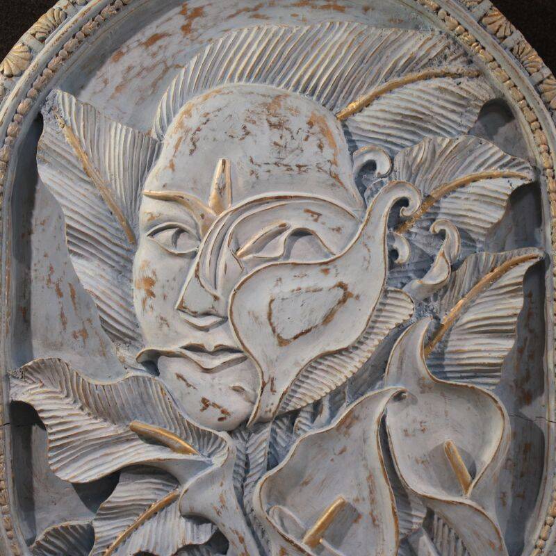 Bas-relief sculpture, stylized face with flowers, 20th century