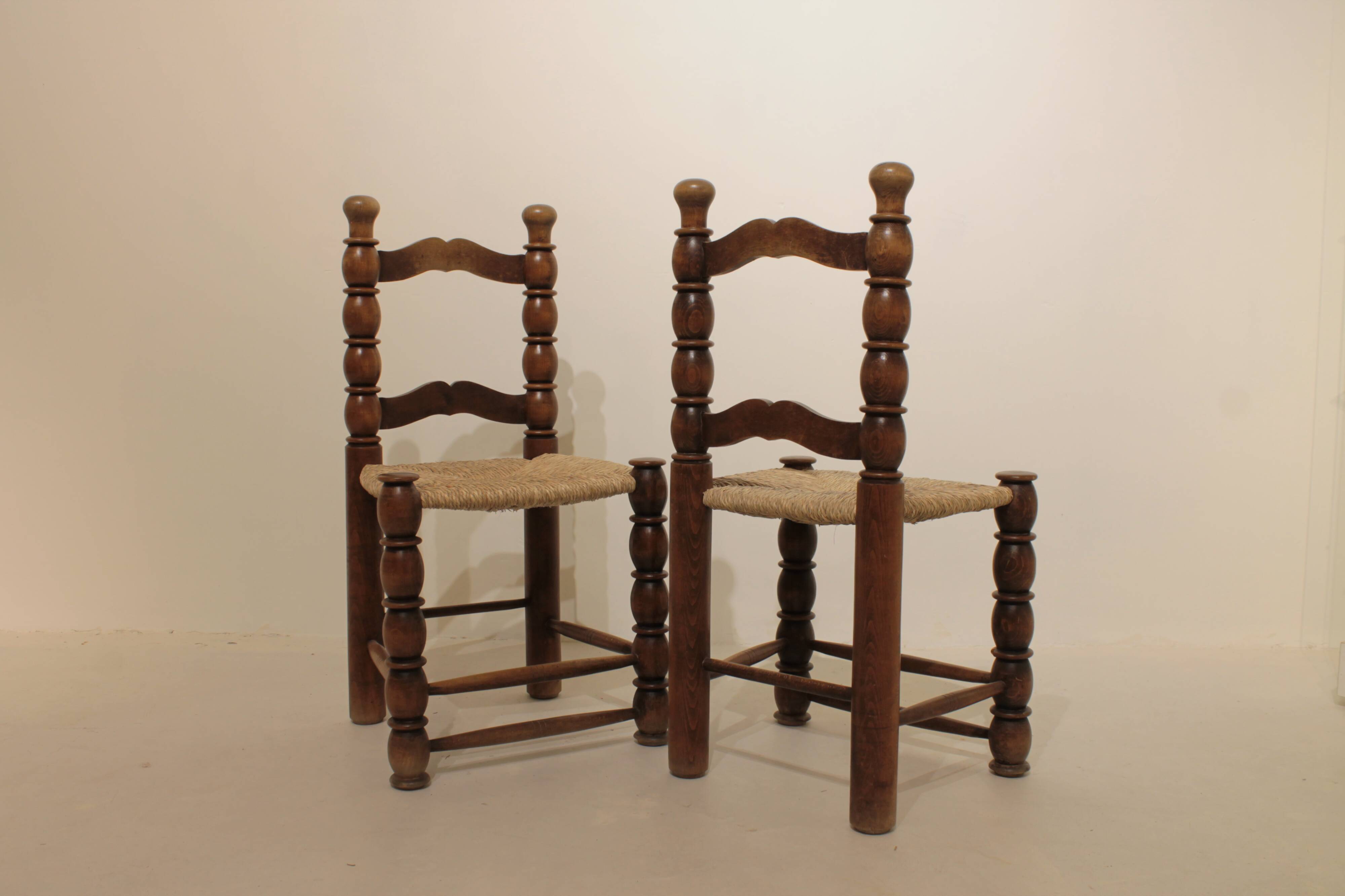 Pair of rustic chairs in turned wood with straw seats