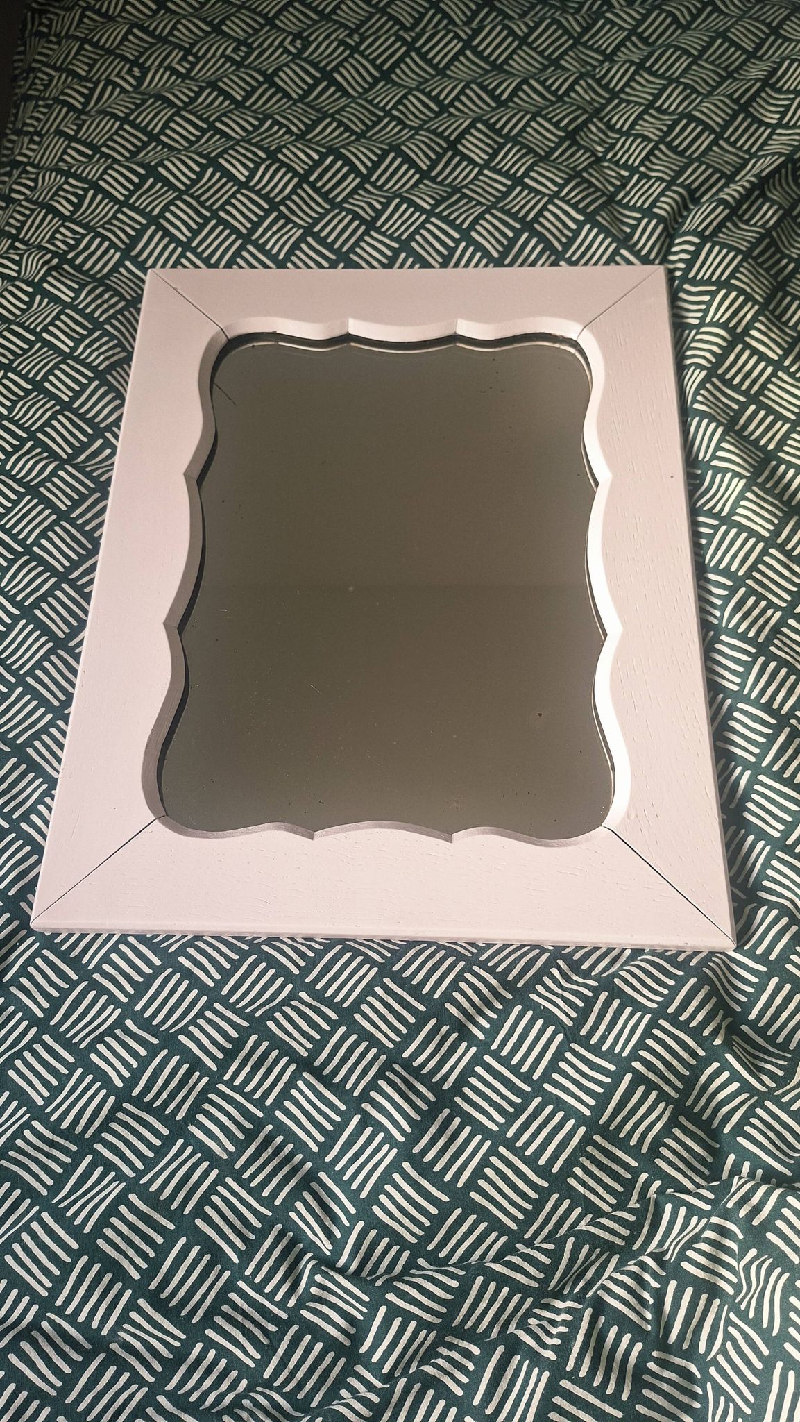 Mid-20th century rectangular wall mirror with a powder pink frame.