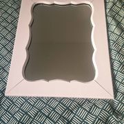 Mid-20th century rectangular wall mirror with a powder pink frame.