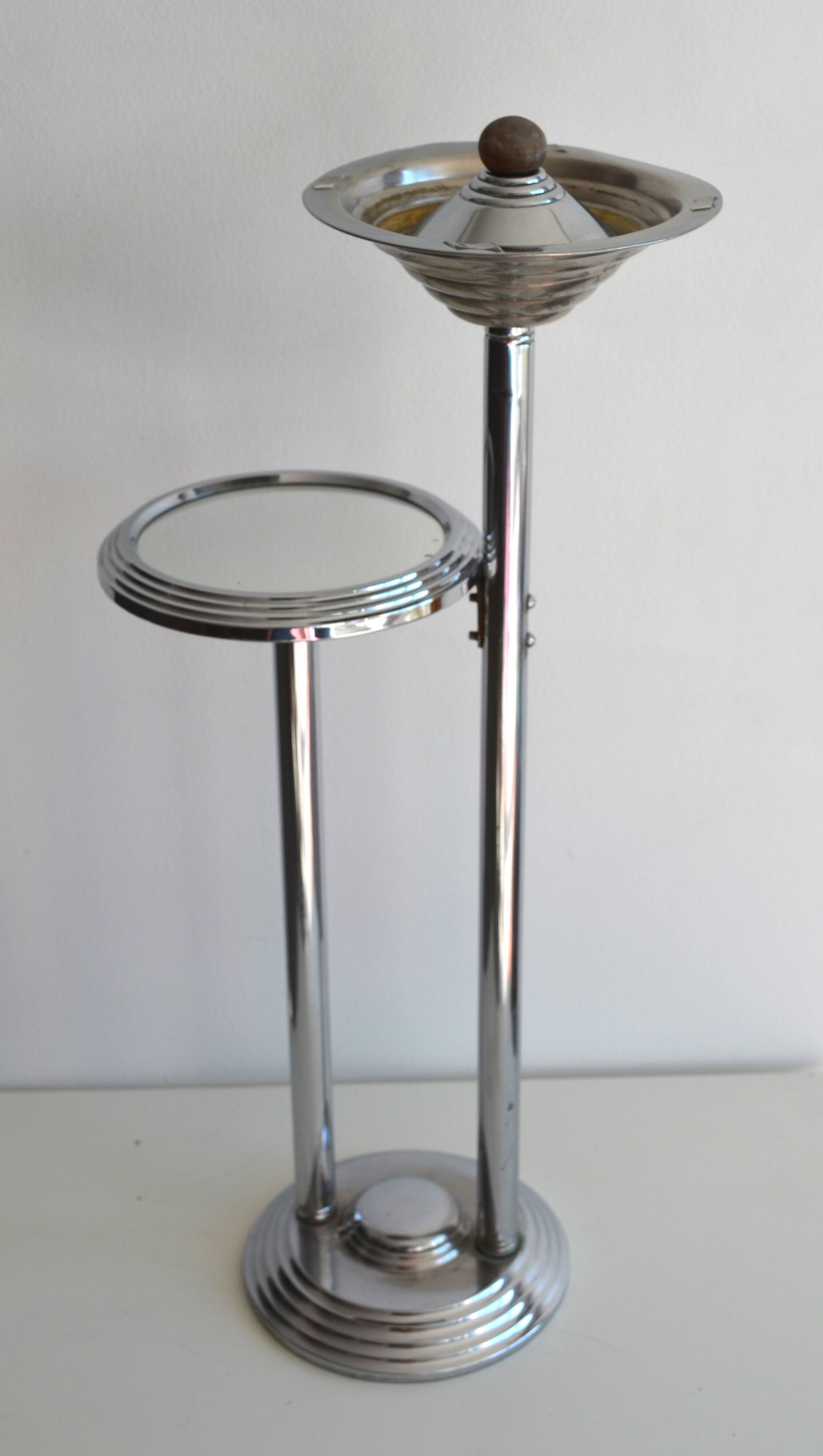 Ashtray and shelf on chrome metal stand.