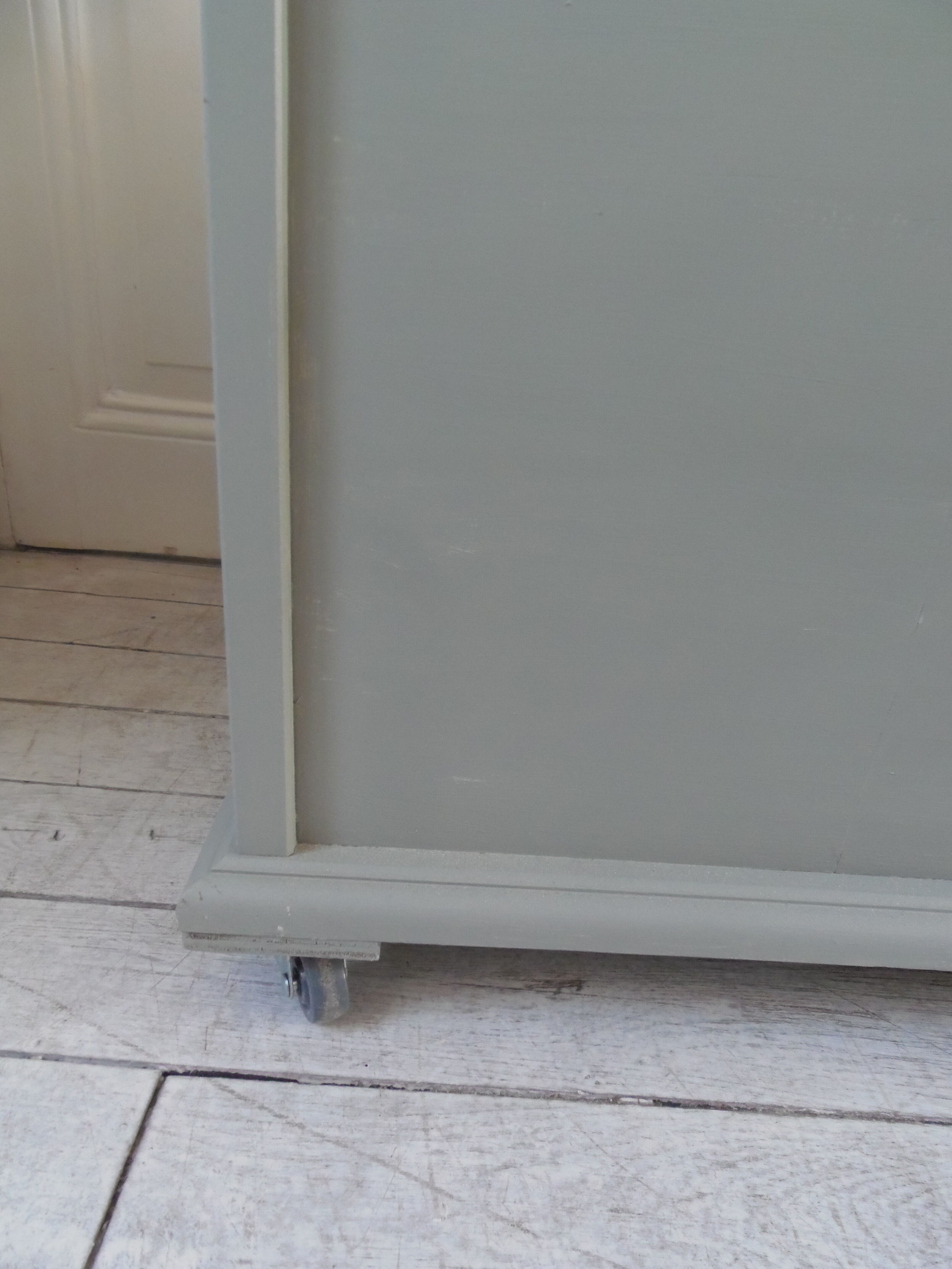 Toy chest on wheels patinated green of gray