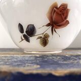 Golden tilting wall light with flowered globe