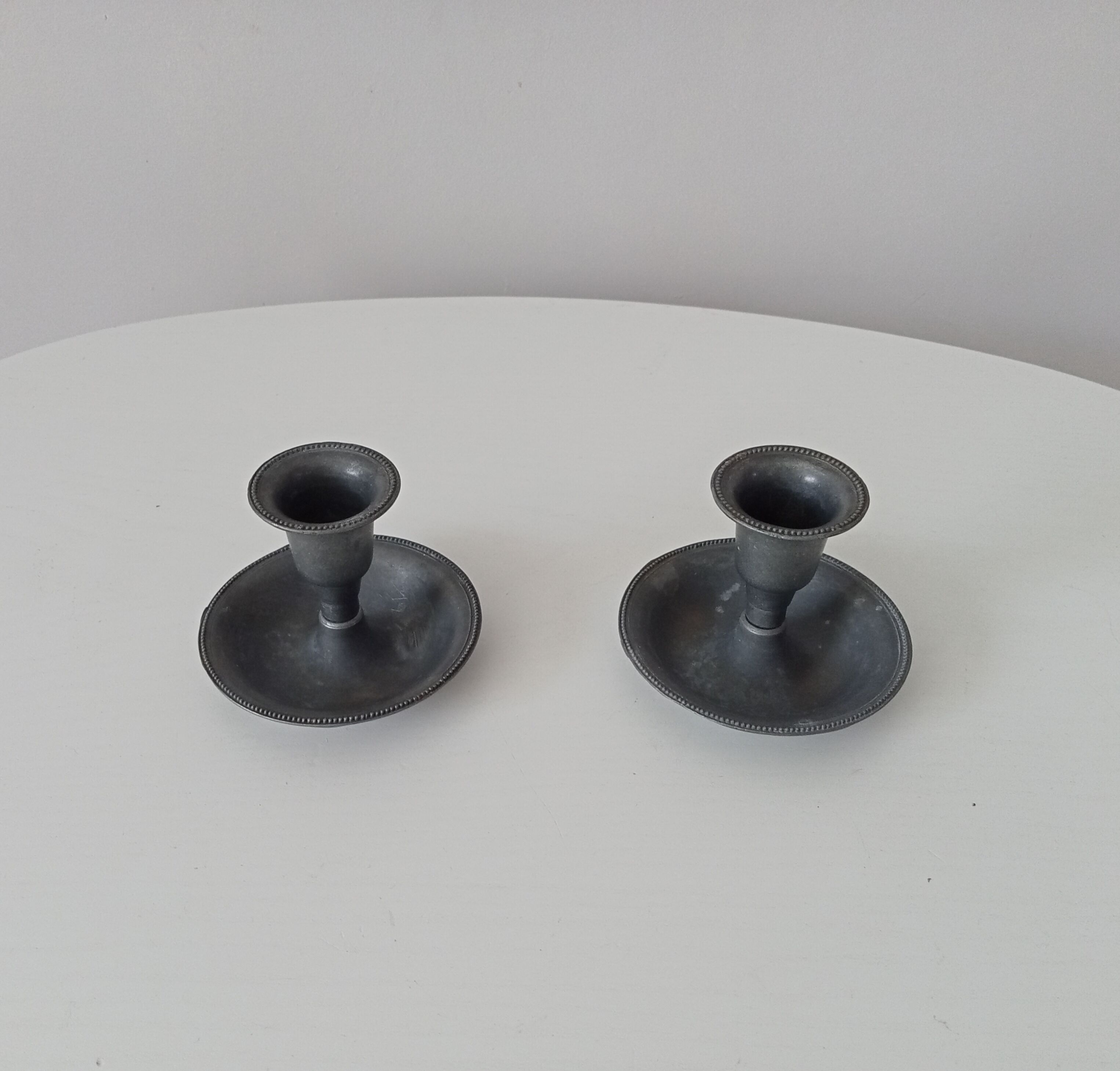 Pair of antique pewter candle holders