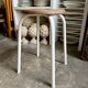 White tubular metal and wood stool