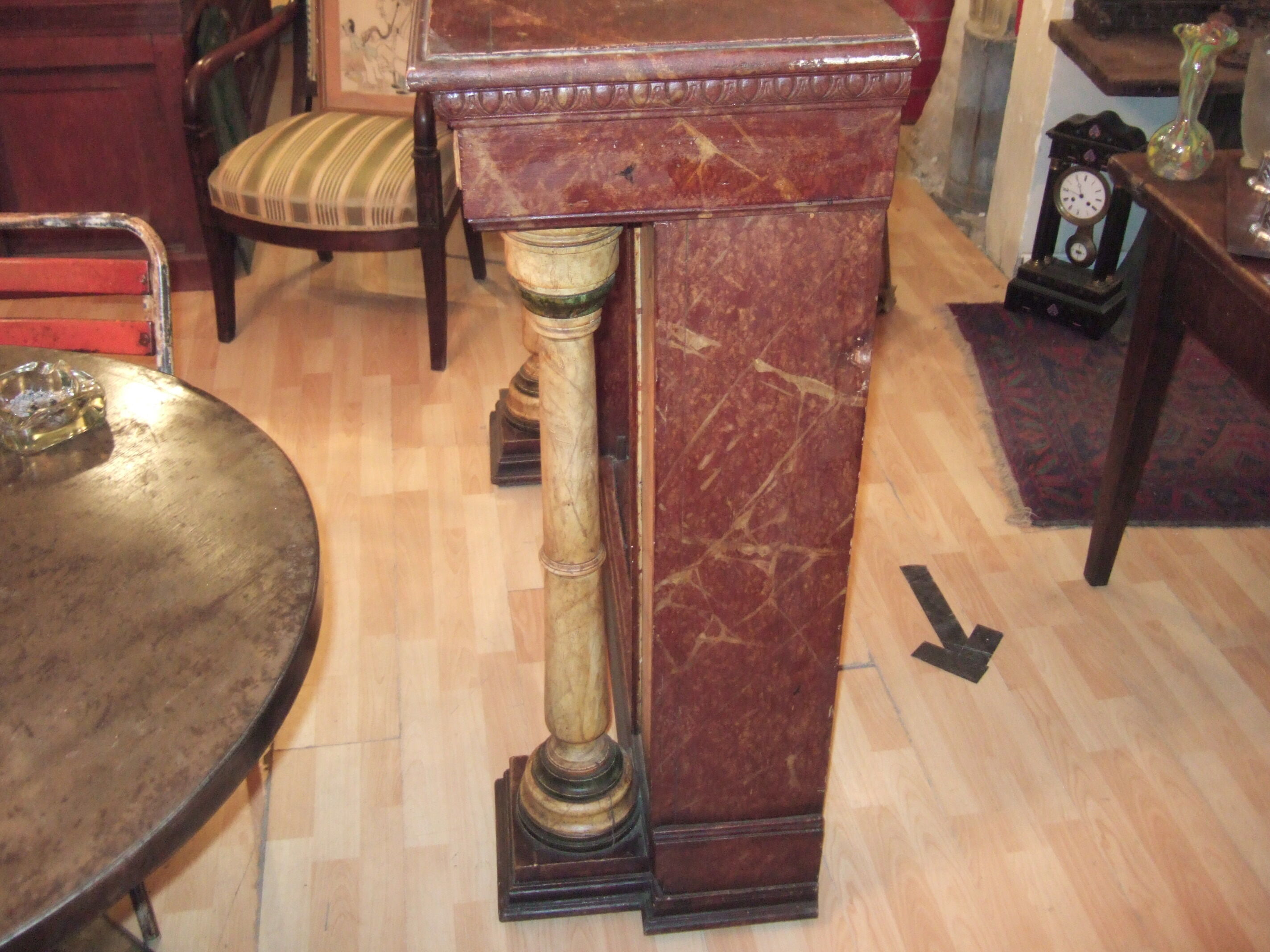 19th century wooden fireplace, faux marble paint. Can act as a console.
