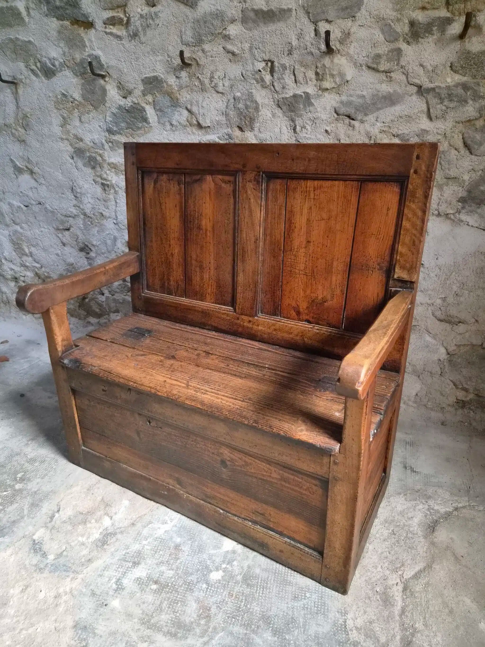 Rustic French antique storage bench from the 18th century in walnut and pine.