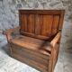 Rustic French antique storage bench from the 18th century in walnut and pine.