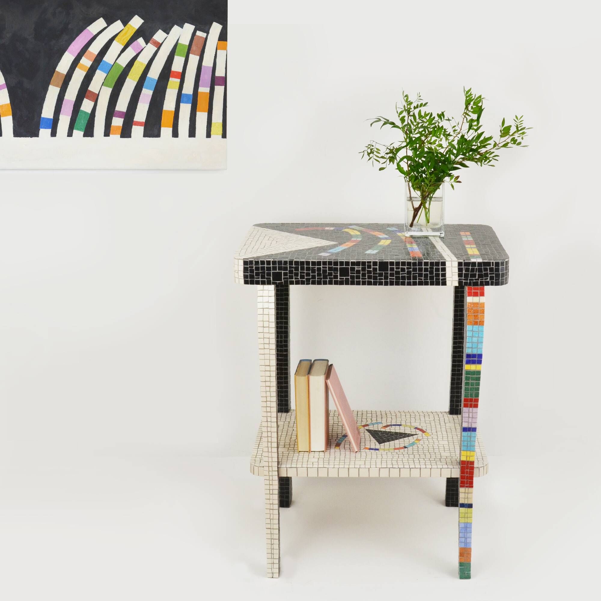 Table topped with a ceramic mosaic featuring an abstract design.