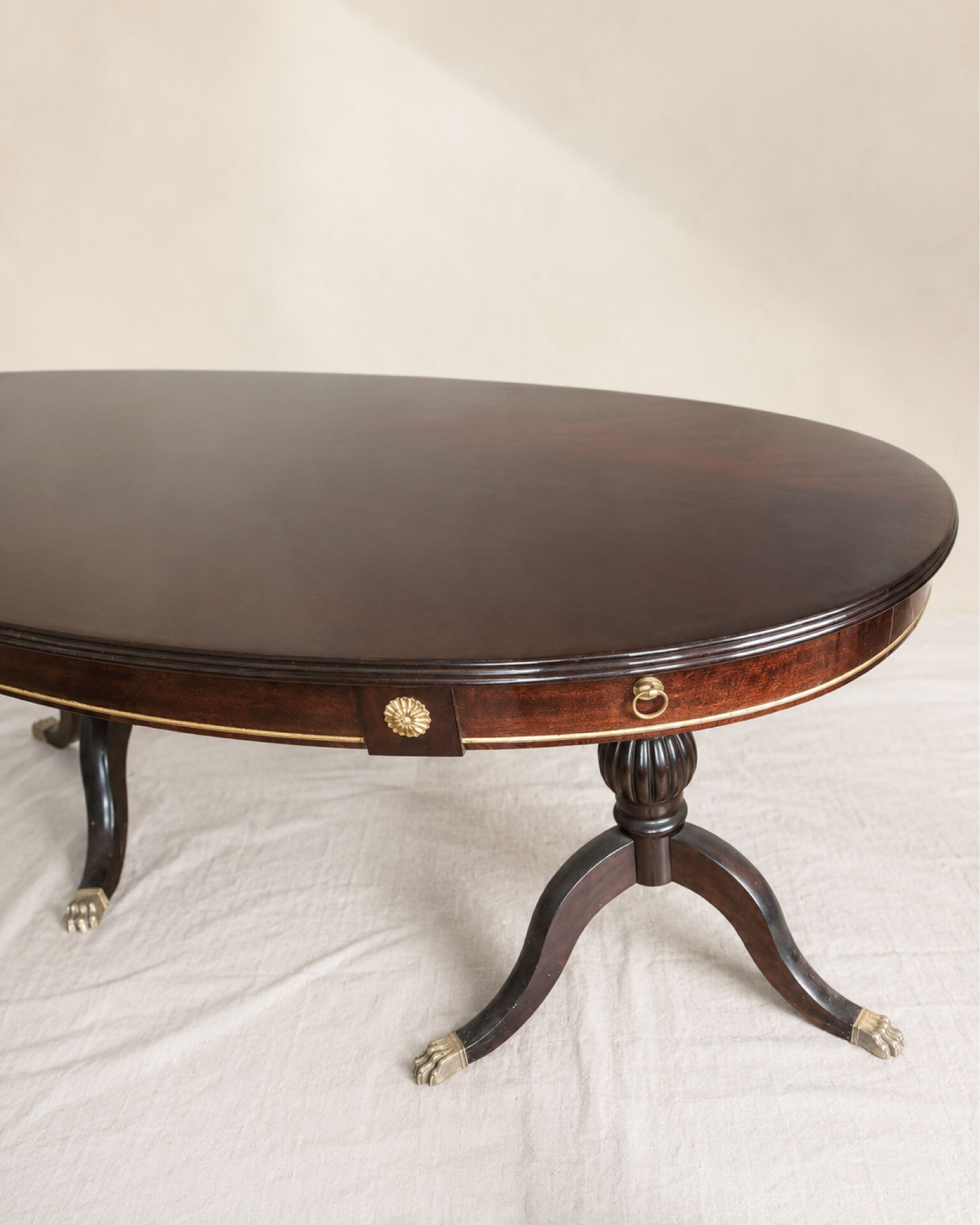 Table ovale extensible en acajou verni, pattes de lion et détails doré