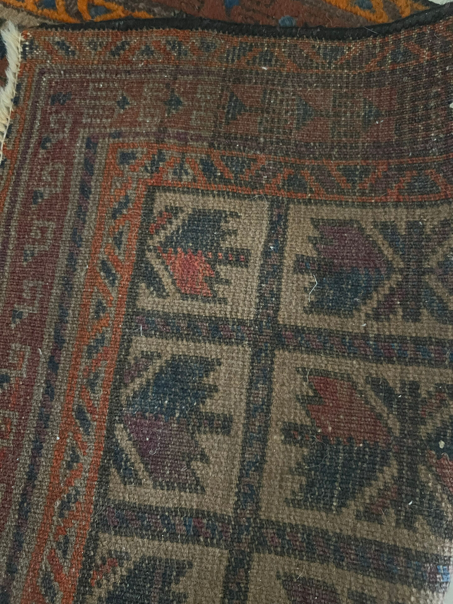 Persian carpet, hand-knotted, geometric design.