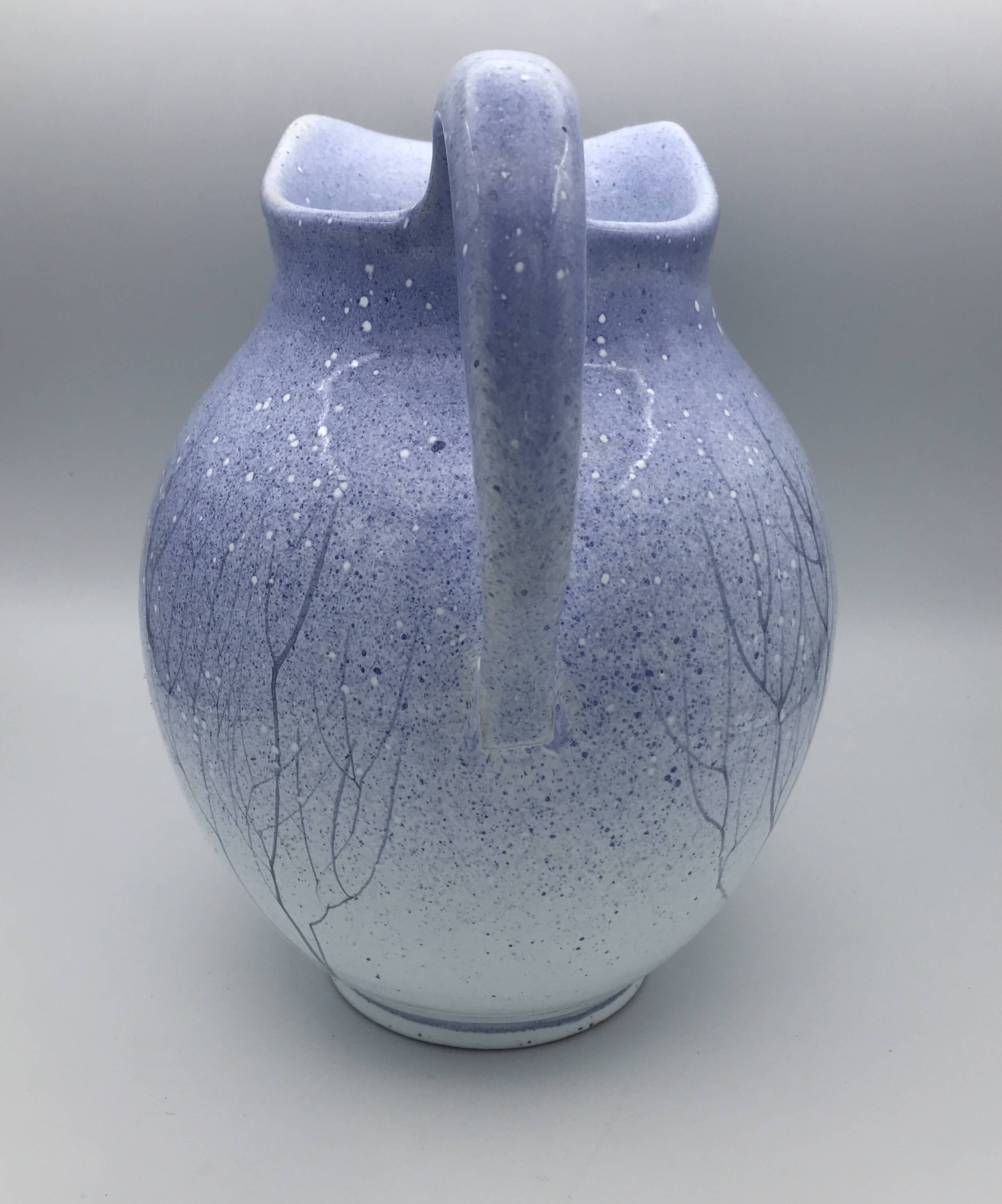 Blue glazed terracotta pitcher with hand-painted decoration, signed