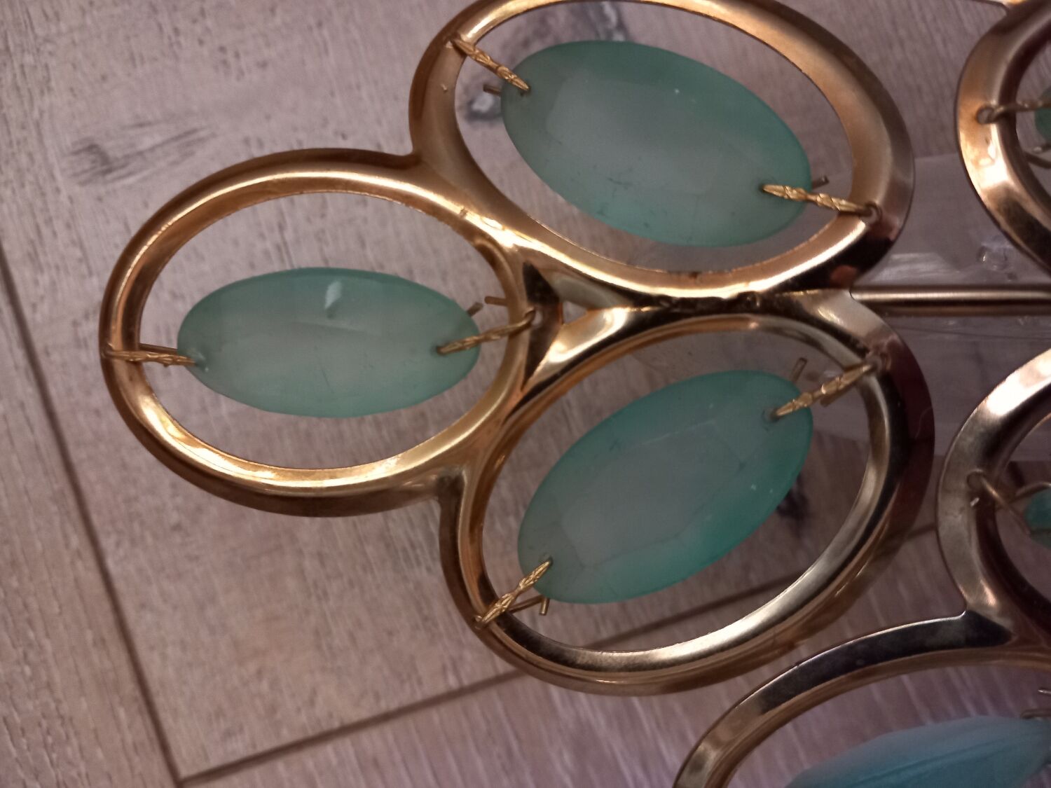 Gold metal wall light with light blue tassels