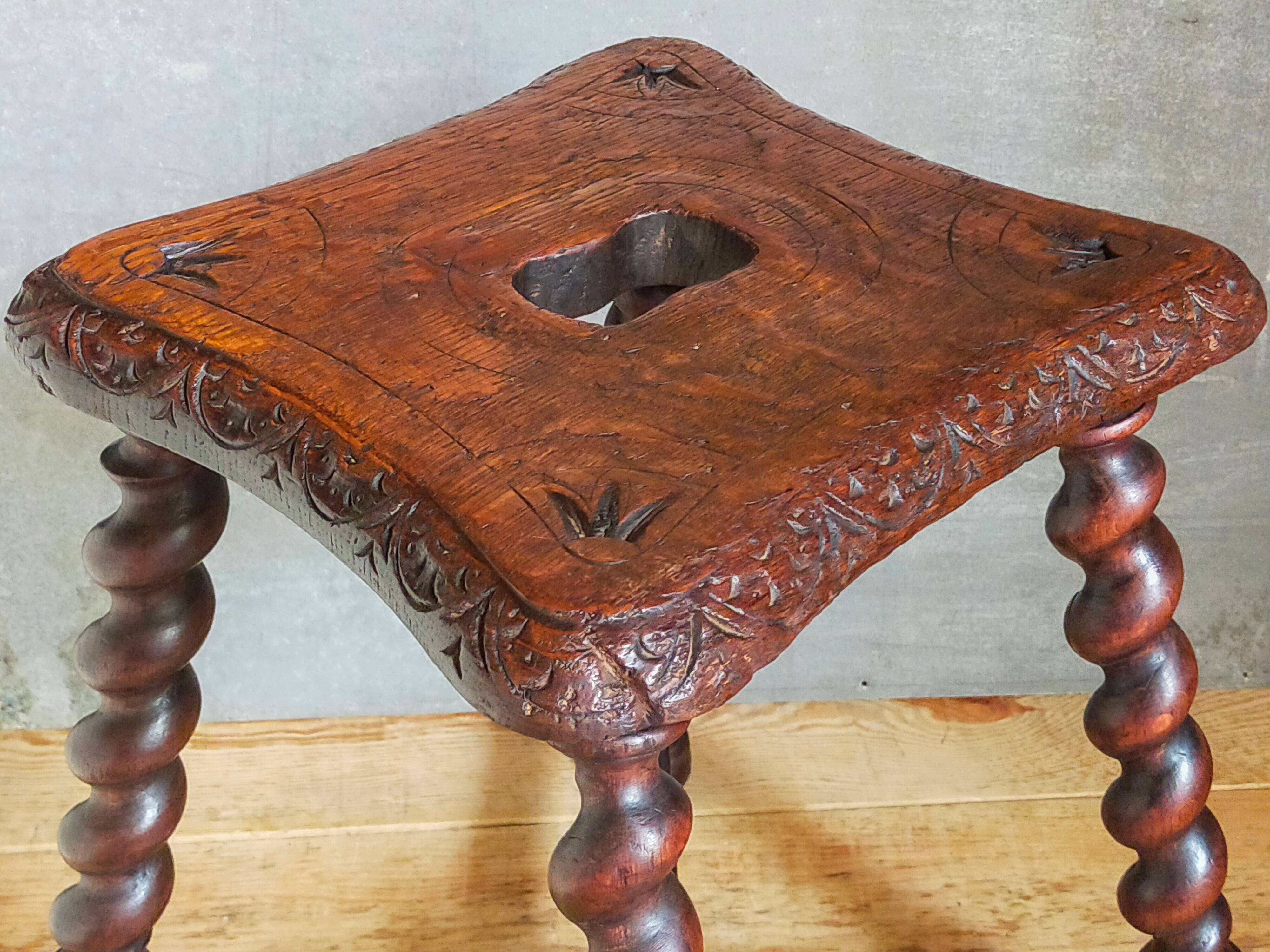Antique stool in turned and carved solid wood
