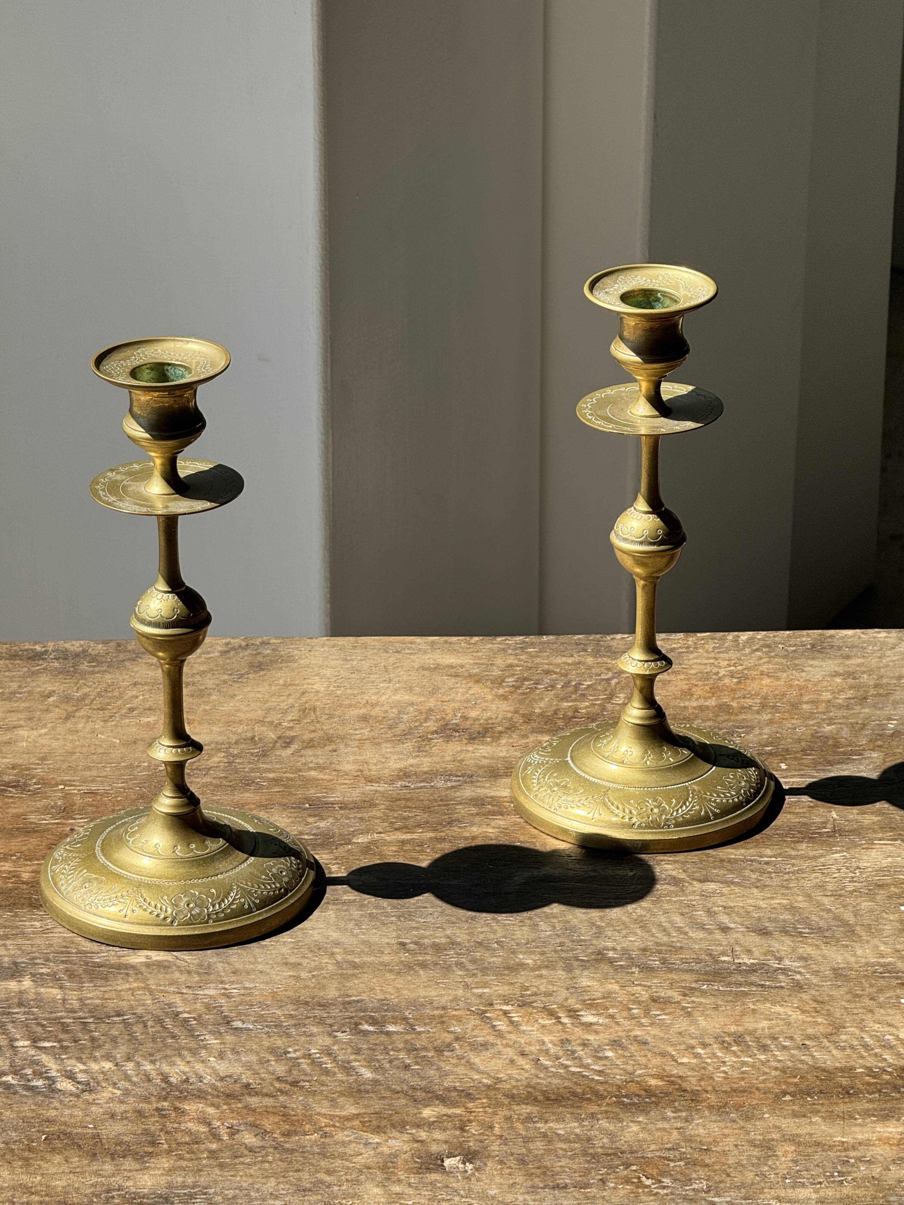 Pair of gilded candlesticks with engraved flower garland motifs H22