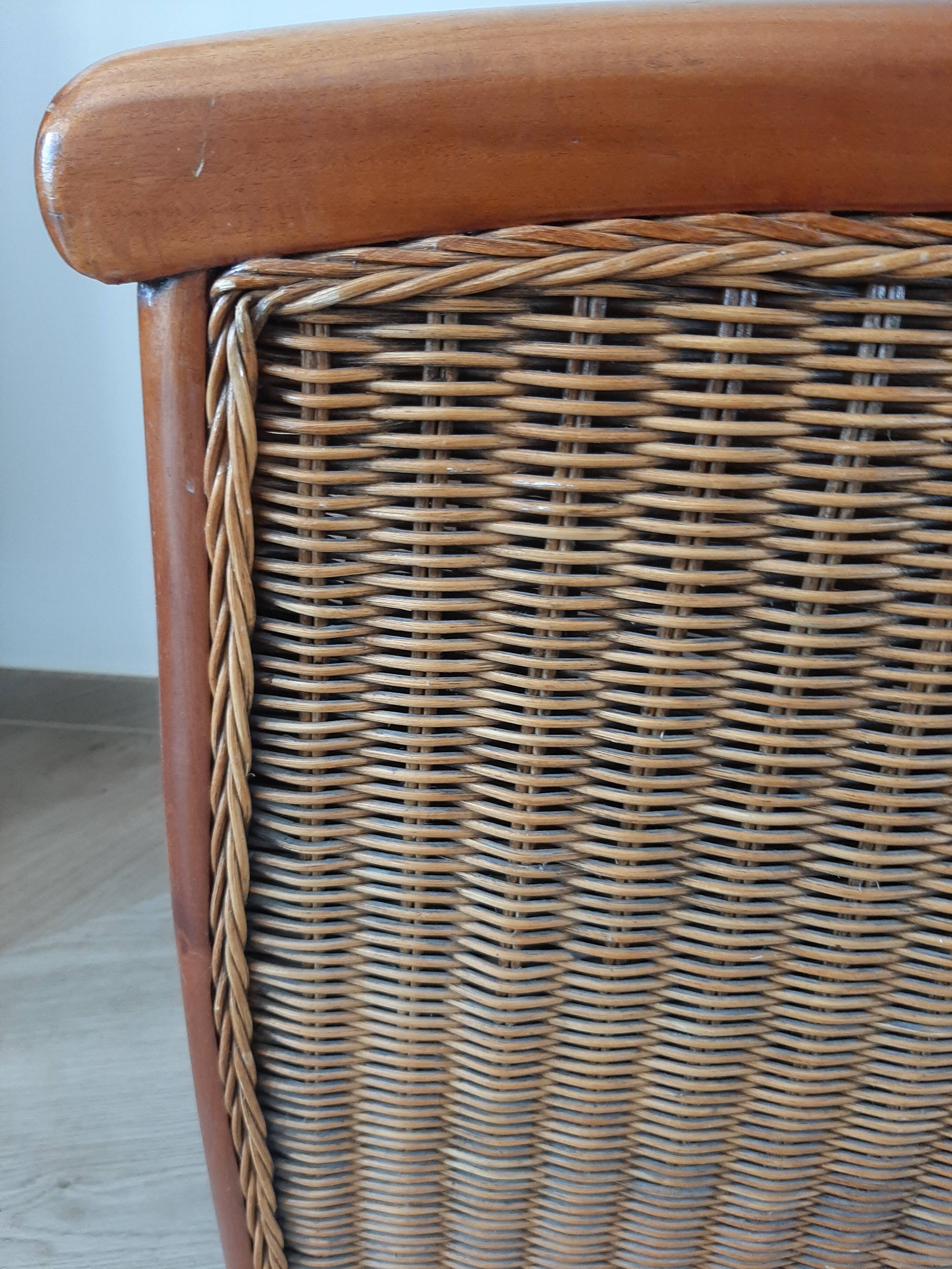 Armchair in woven rattan and exotic wood