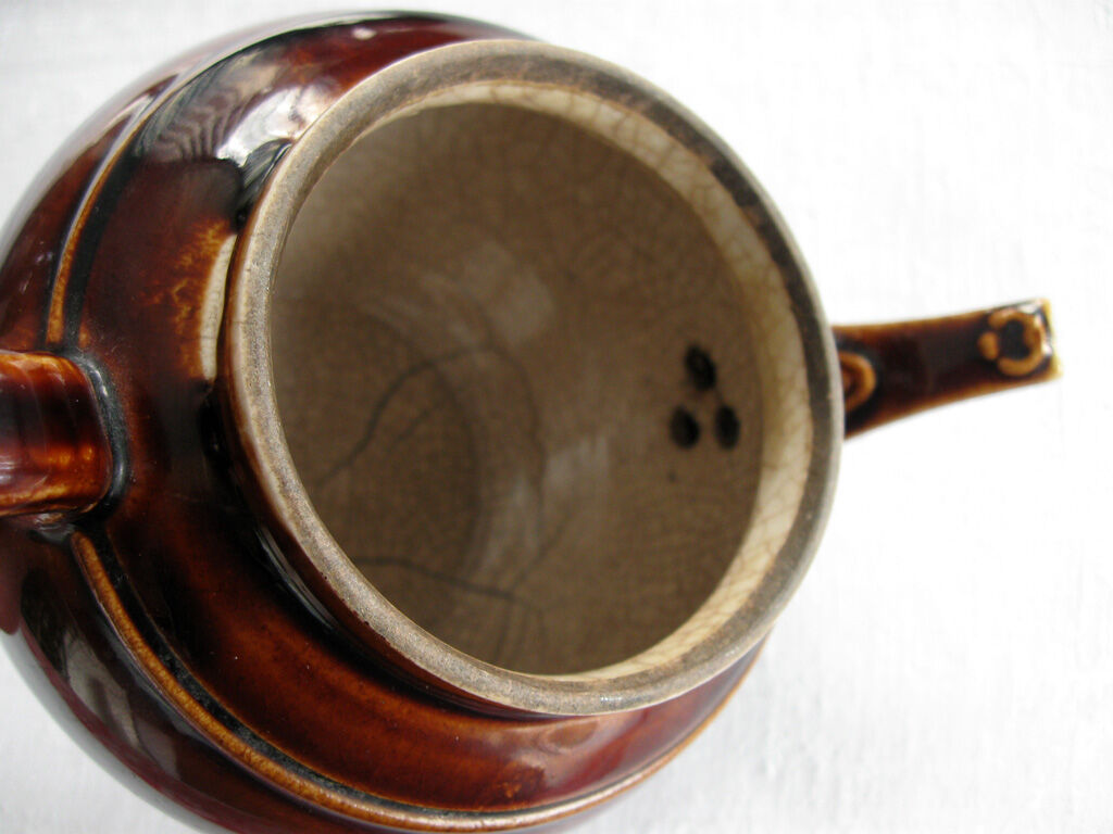 Old brown glazed ceramic coffee pot