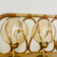 2 bedside lamps with round amber glass globes and gold metal.