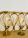 2 bedside lamps with round amber glass globes and gold metal.