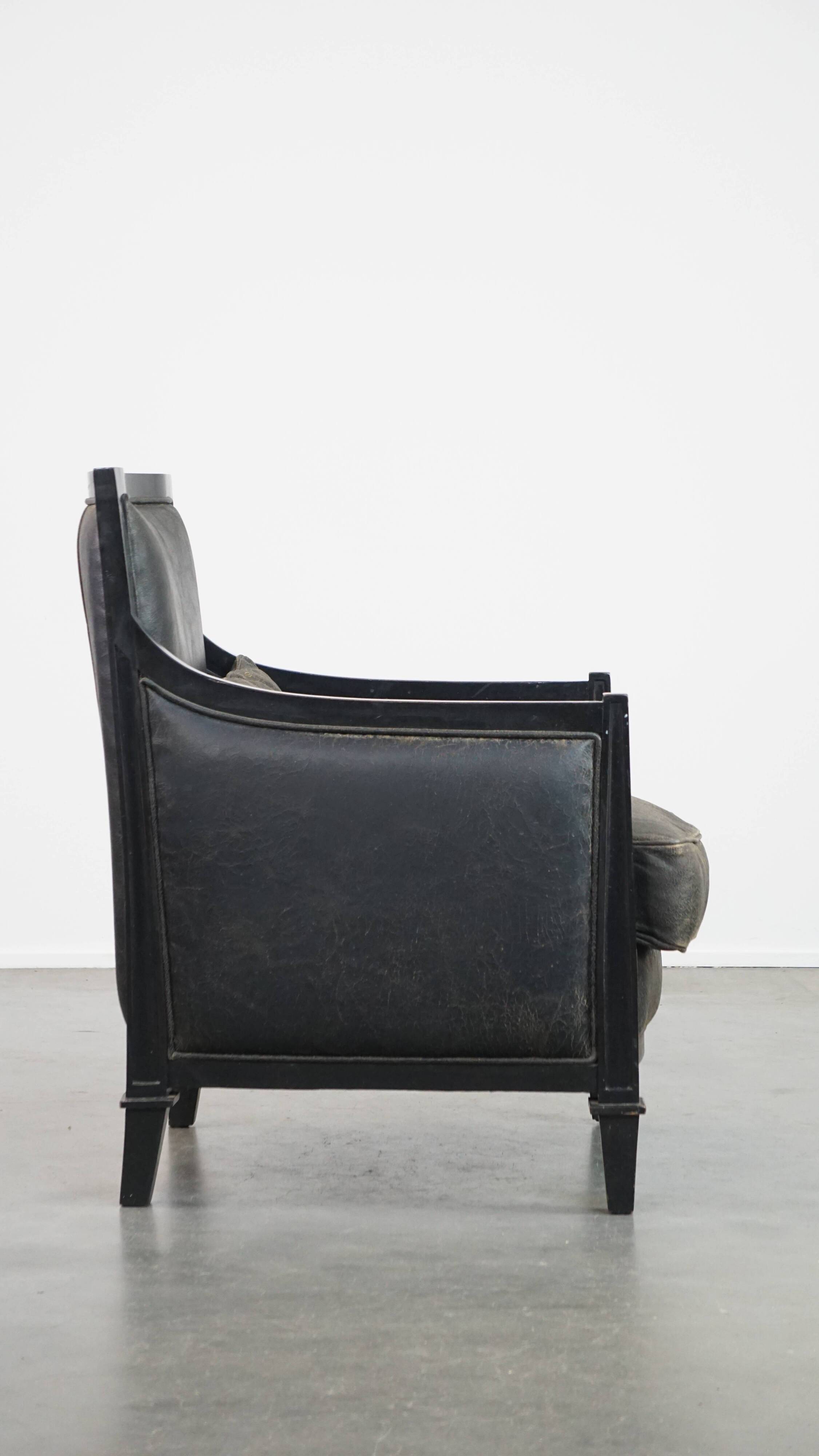Armchair in black cowhide leather and wood with an Art Deco design