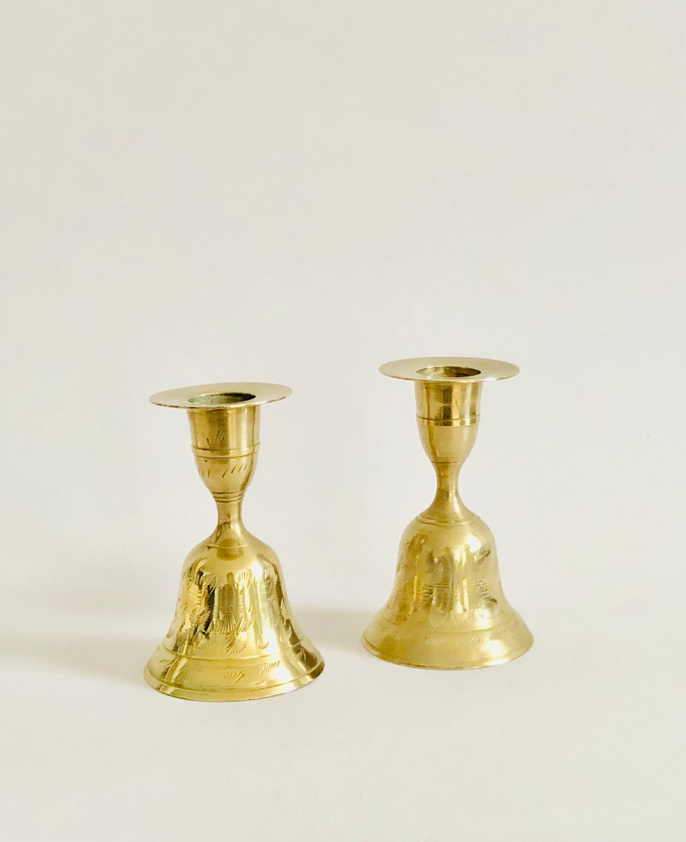 Pair of brass "bell" candle holders