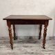Antique wooden desk with a drawer.