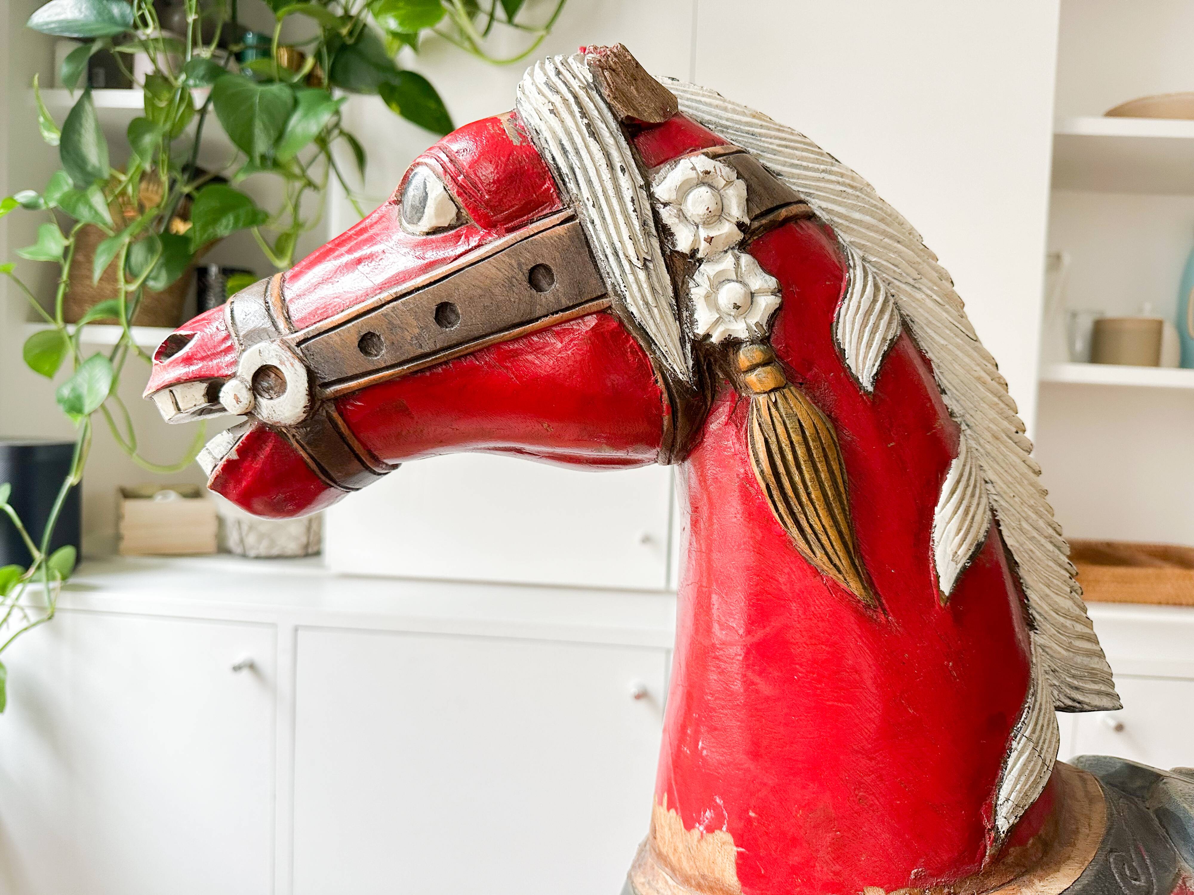 Large decorative rocking horse made of carved and hand-painted wood.