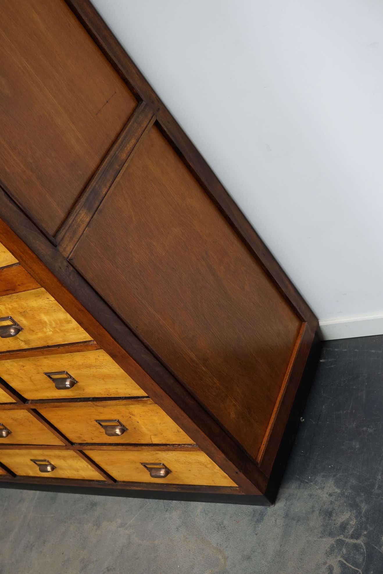 School cabinet bank of vintage Dutch drawers in mid-twentieth century pine