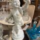 Child statue with flowers in porcelain, signed.