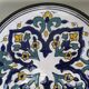 Round ceramic plate with hand-painted decoration